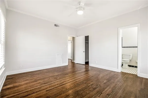 an empty room with wooden floor and closet
