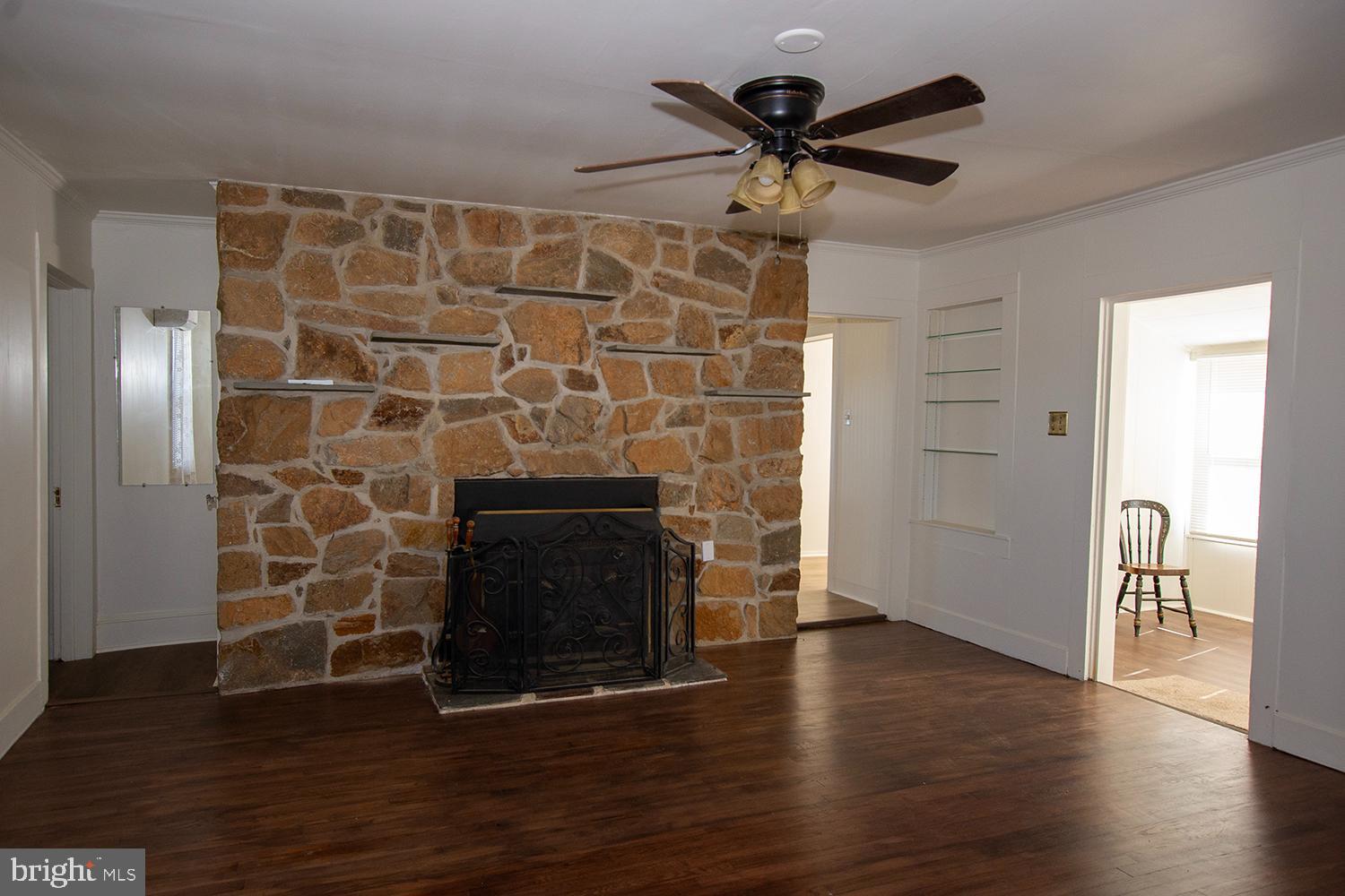 34463 Rider Road Delmar, DE 19940 - Photo 11 of 47 a living room with wooden floor and a fireplace