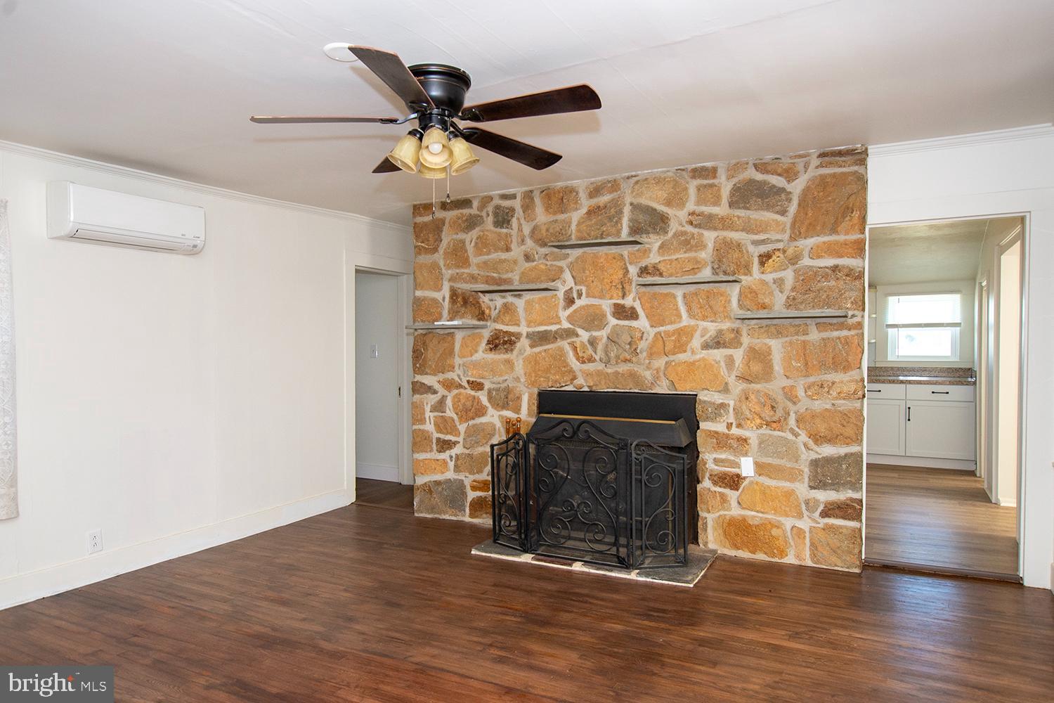 34463 Rider Road Delmar, DE 19940 - Photo 10 of 47 a view of a livingroom with wooden floor a fireplace and a window
