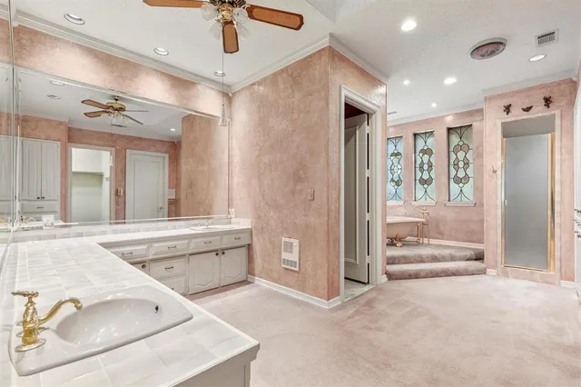 a large en suite bathroom with a tub shower and sink