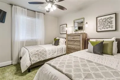 a bedroom with two bed and a chandelier