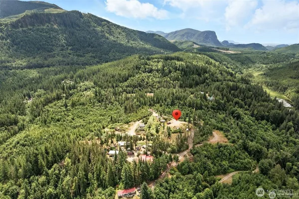 a view of a houses with a lush green hillside