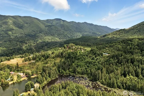 a view of a houses with a lush green hillside