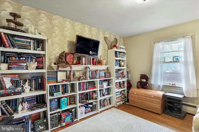 a bedroom with furniture and a book shelf