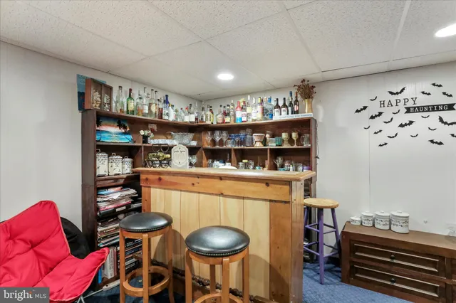 a room with furniture a rug and a bookshelf