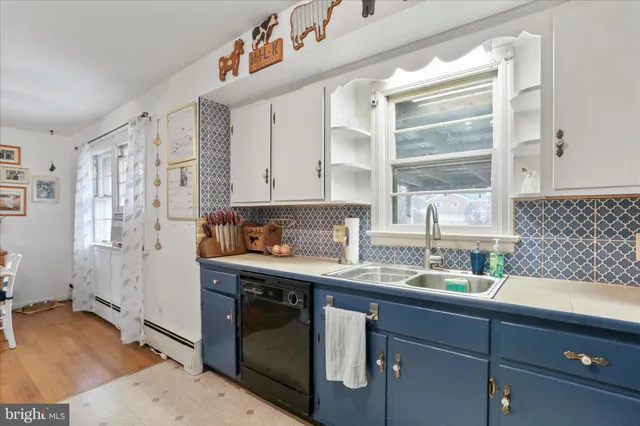 a kitchen with stainless steel appliances granite countertop a sink and a stove next to a window