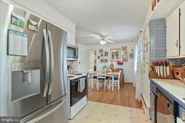 a kitchen with stainless steel appliances granite countertop a refrigerator and a stove top oven