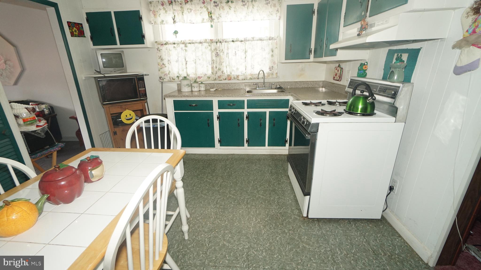 2832 Berwyn Road Bensalem, PA 19020 - Photo 4 of 12 a view of a kitchen with furniture and a window
