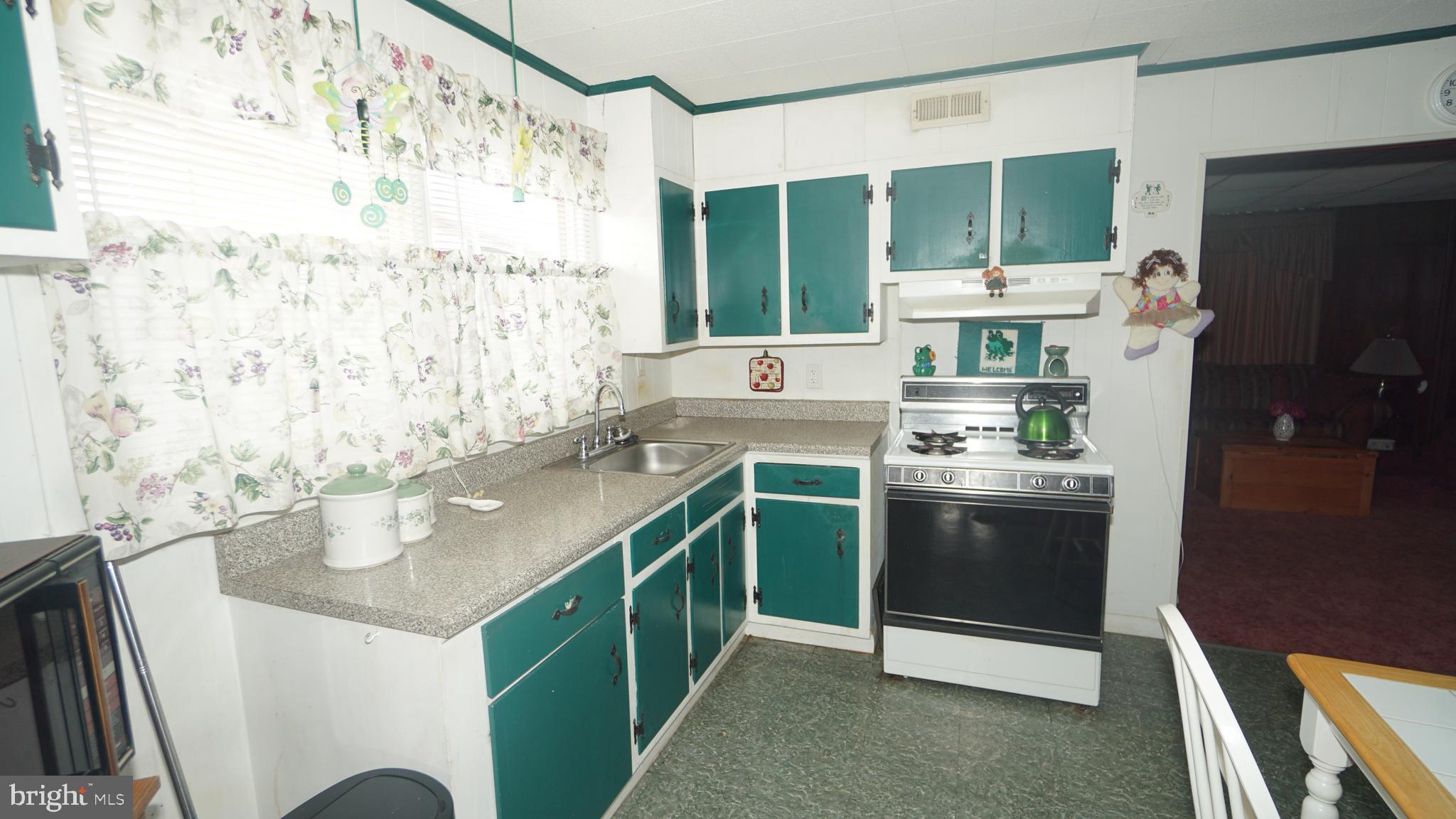 2832 Berwyn Road Bensalem, PA 19020 - Photo 5 of 12 a kitchen with stainless steel appliances granite countertop a sink stove and refrigerator