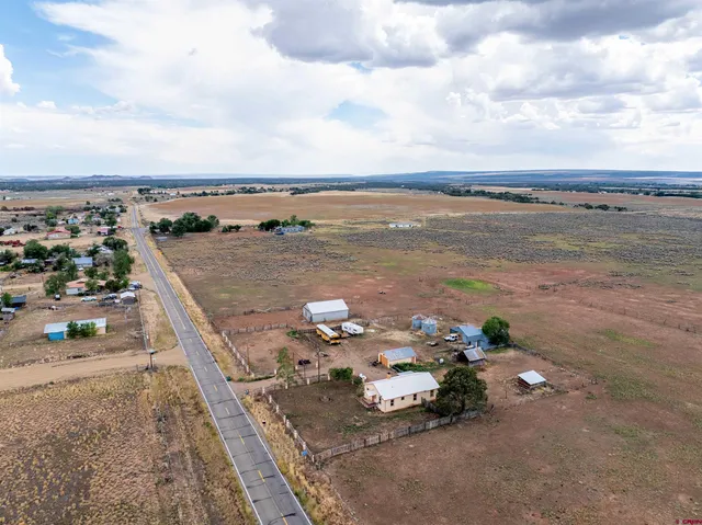 a view of a terrace with lawn chairs