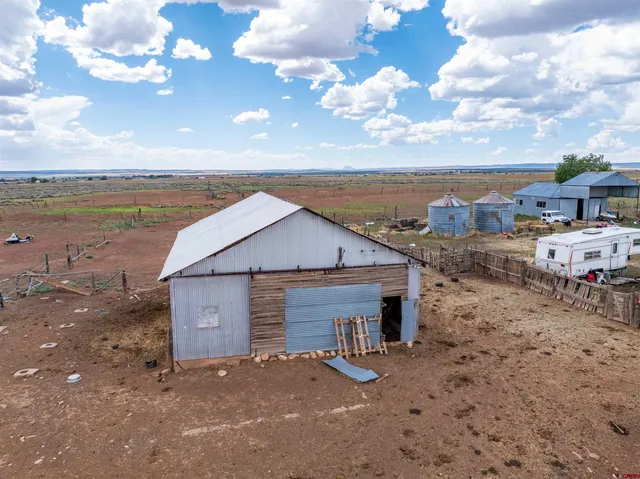 a view of a terrace with lawn chairs