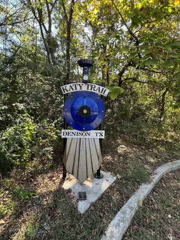 a view of a field with a tree in the background
