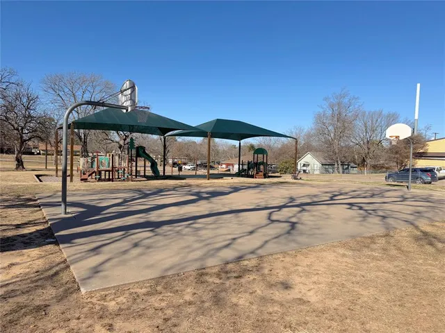 a patio with a table and chairs under an umbrella