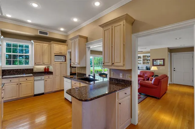 a kitchen with sink stove and cabinets