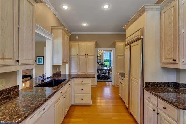a large kitchen with stainless steel appliances granite countertop a stove a sink and a refrigerator