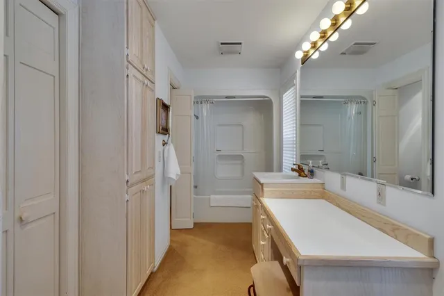 a bathroom with a tub sink and mirror