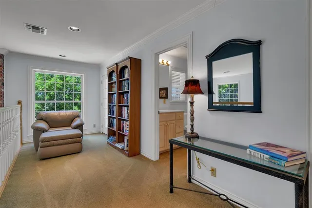 a living room with furniture and a book shelf