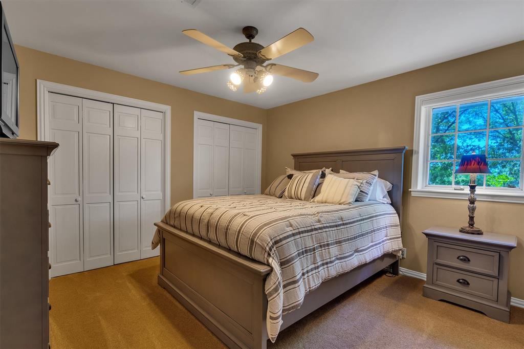 192301 North 4205th Road Antlers, OK 74523 - Photo 26 of 40 a spacious bedroom with a bed and a chandelier