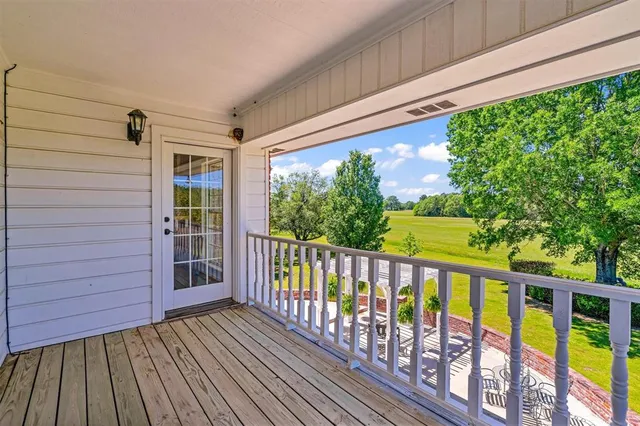 a view of a patio with a table chairs and a backyard