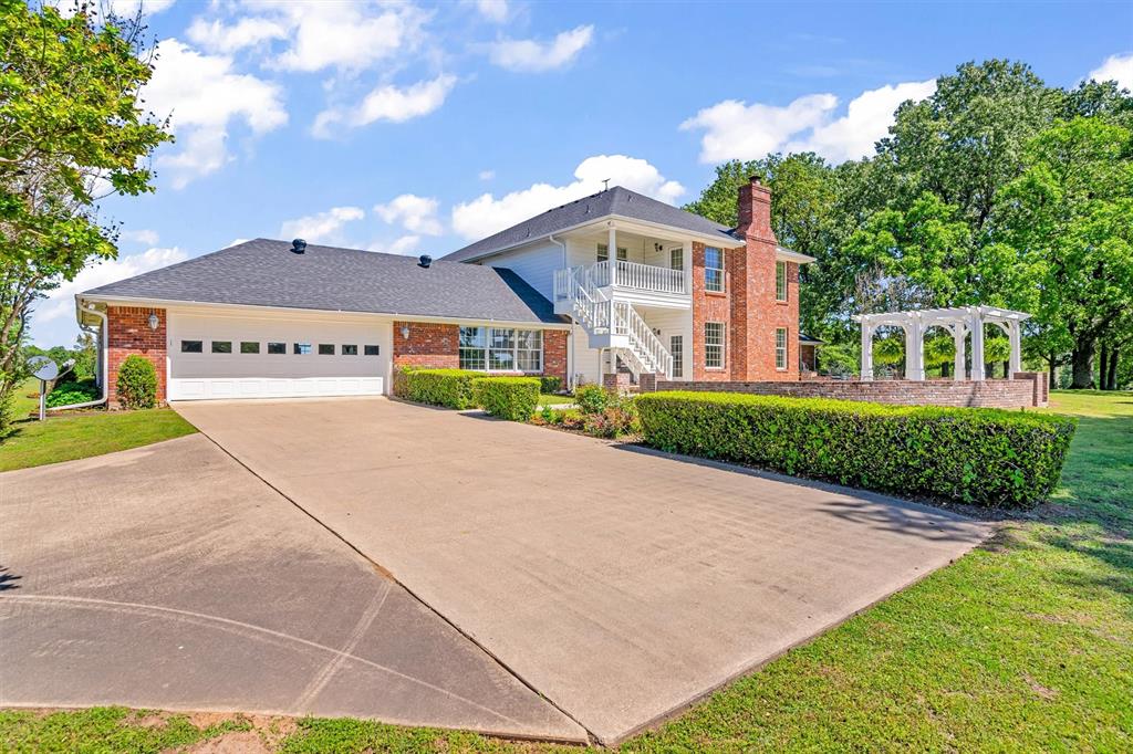 192301 North 4205th Road Antlers, OK 74523 - Photo 34 of 40 a front view of a house with a yard and garage