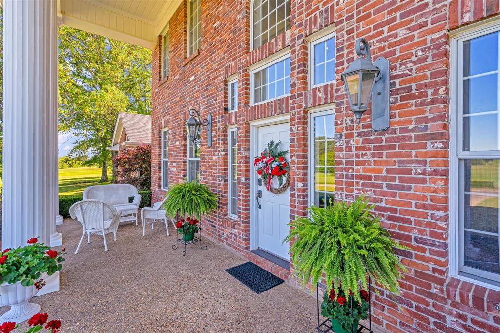 192301 North 4205th Road Antlers, OK 74523 - Photo 5 of 40 a view of a patio with plants and table and chairs under an umbrella
