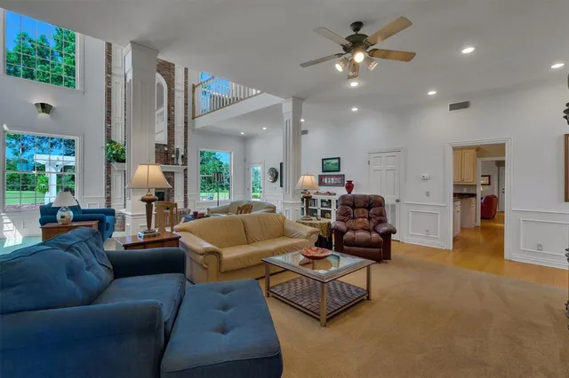 a living room with furniture and a chandelier