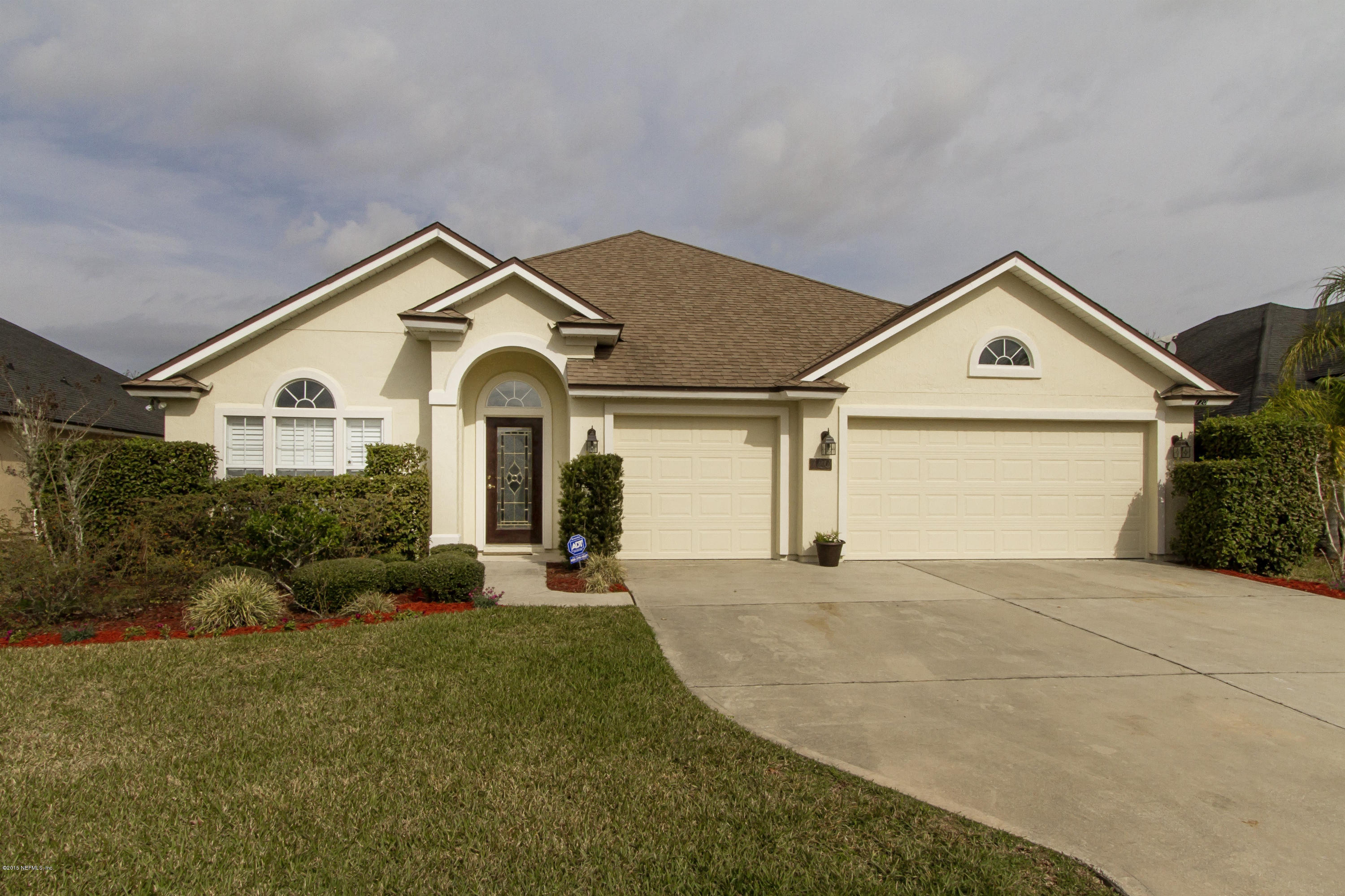 720 Porta Rosa Circle St. Augustine, FL 32092 - Photo 1 of 26 a front view of a house with a yard and garage