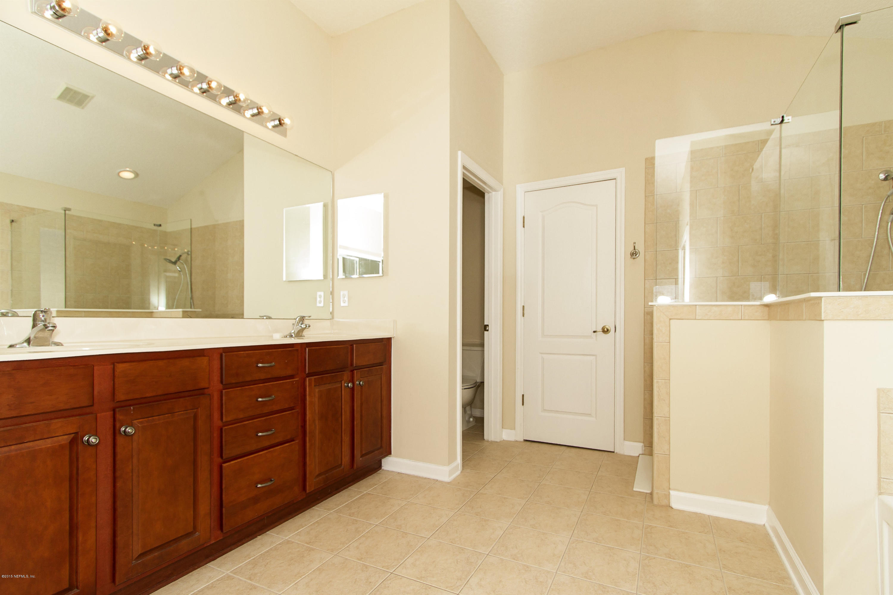 720 Porta Rosa Circle St. Augustine, FL 32092 - Photo 15 of 26 a spacious bathroom with a shower sink and mirror