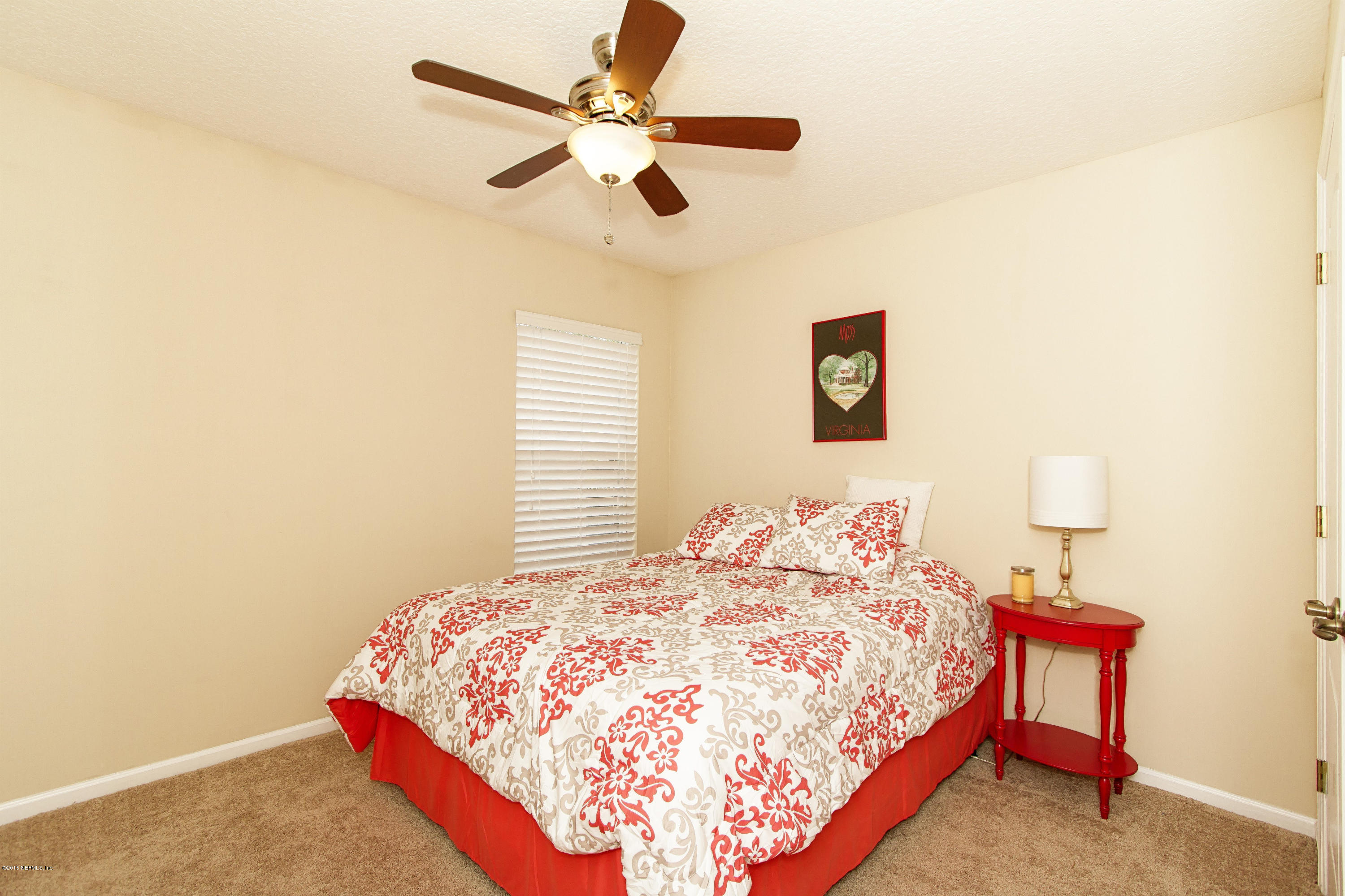 720 Porta Rosa Circle St. Augustine, FL 32092 - Photo 17 of 26 a bedroom with a bed and a chandelier