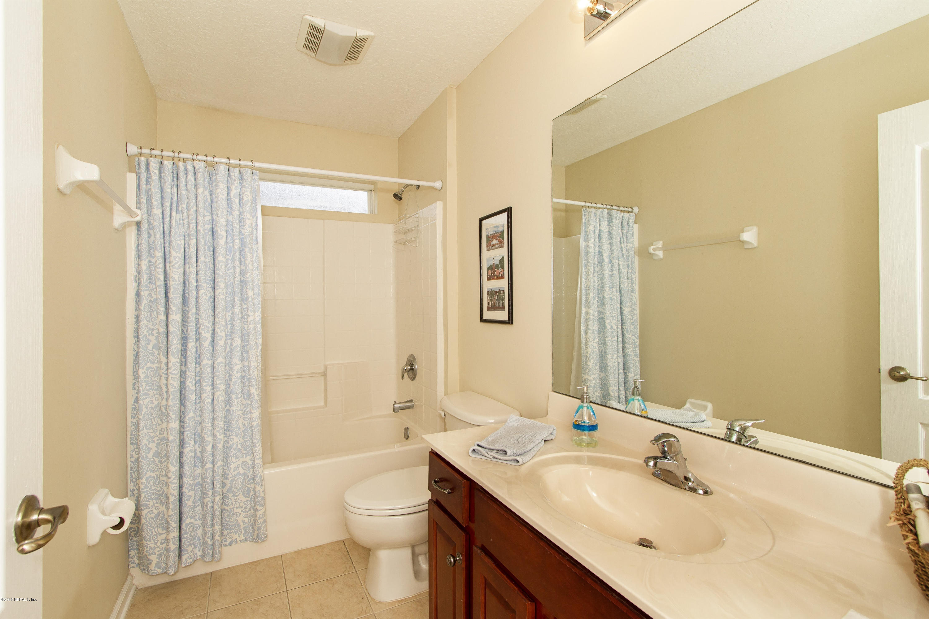 720 Porta Rosa Circle St. Augustine, FL 32092 - Photo 18 of 26 a bathroom with a double vanity sink toilet mirror and shower