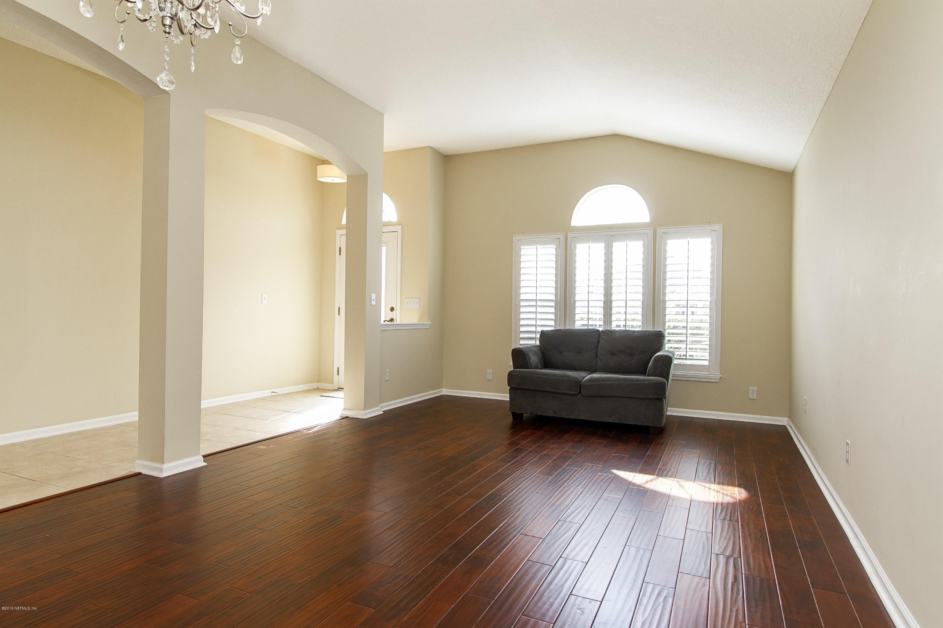 720 Porta Rosa Circle St. Augustine, FL 32092 - Photo 2 of 26 a living room with a couch and a wooden floor