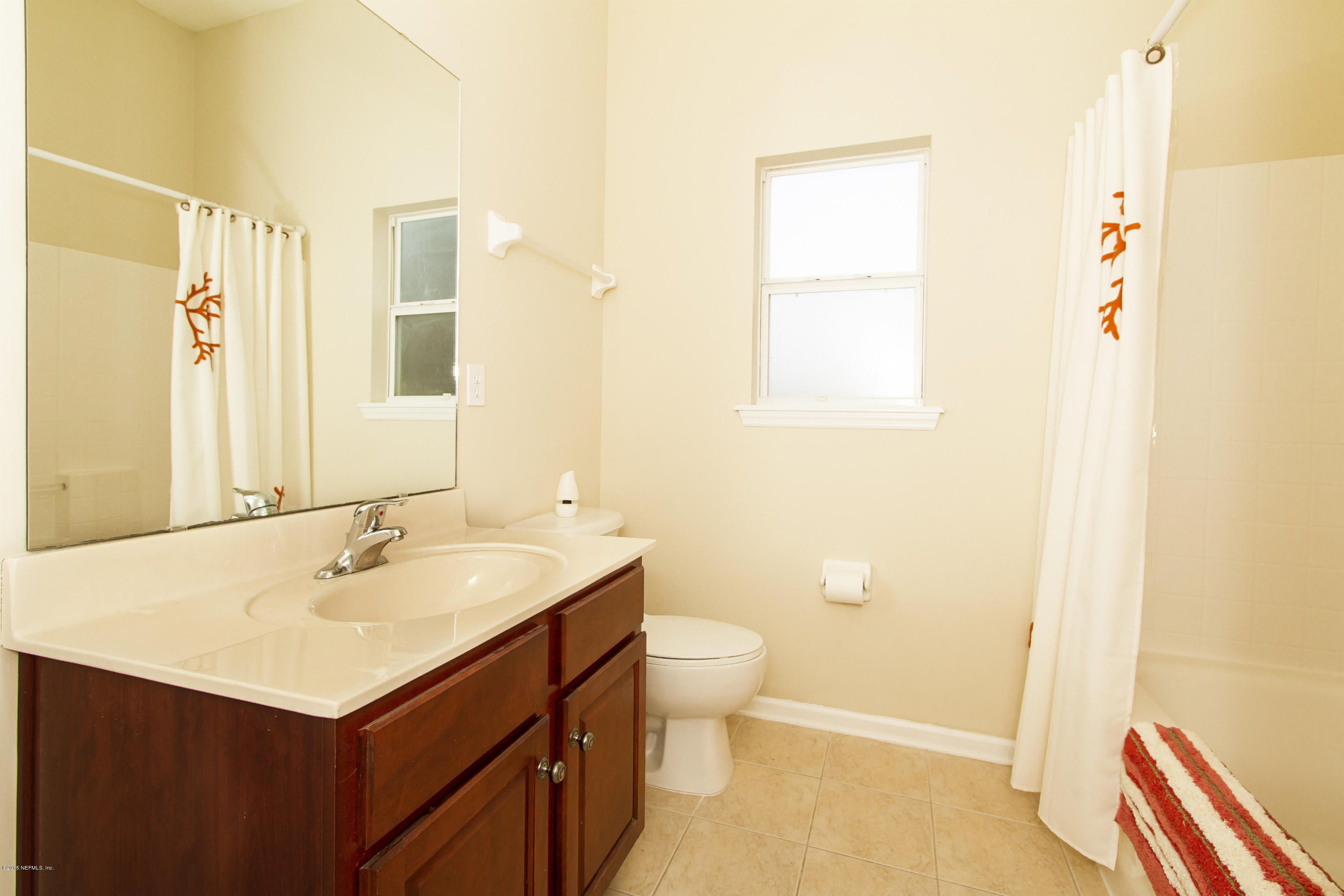 720 Porta Rosa Circle St. Augustine, FL 32092 - Photo 21 of 26 a bathroom with a sink and a mirror