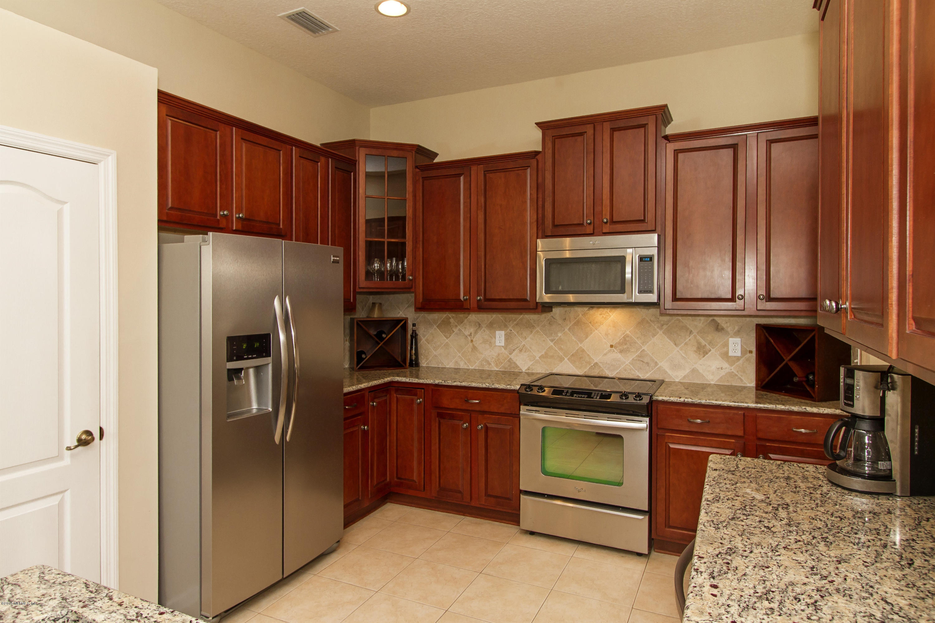 720 Porta Rosa Circle St. Augustine, FL 32092 - Photo 8 of 26 a kitchen with stainless steel appliances granite countertop a refrigerator stove a sink and dishwasher
