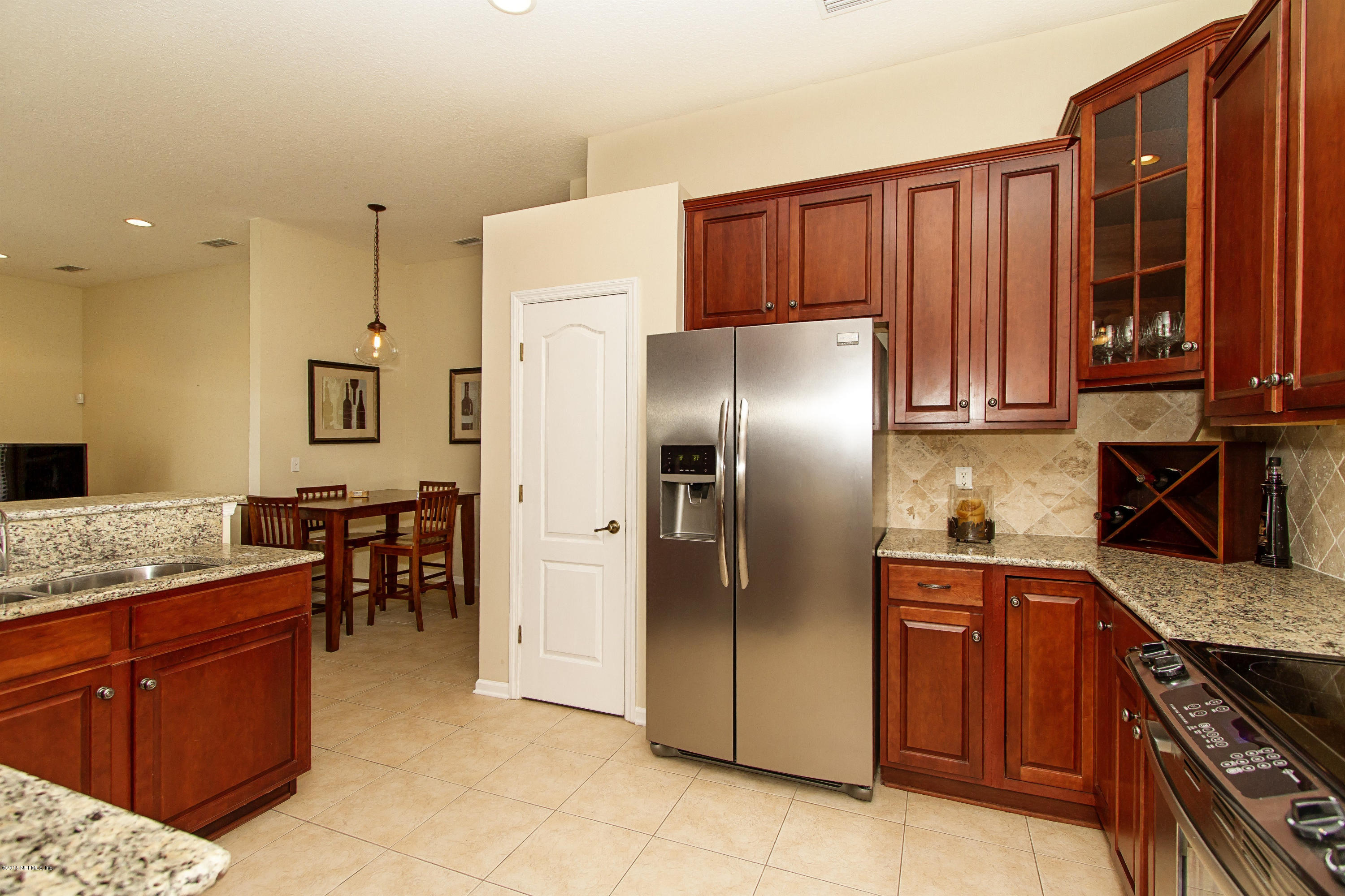 720 Porta Rosa Circle St. Augustine, FL 32092 - Photo 9 of 26 a kitchen with stainless steel appliances granite countertop a refrigerator and a stove top oven