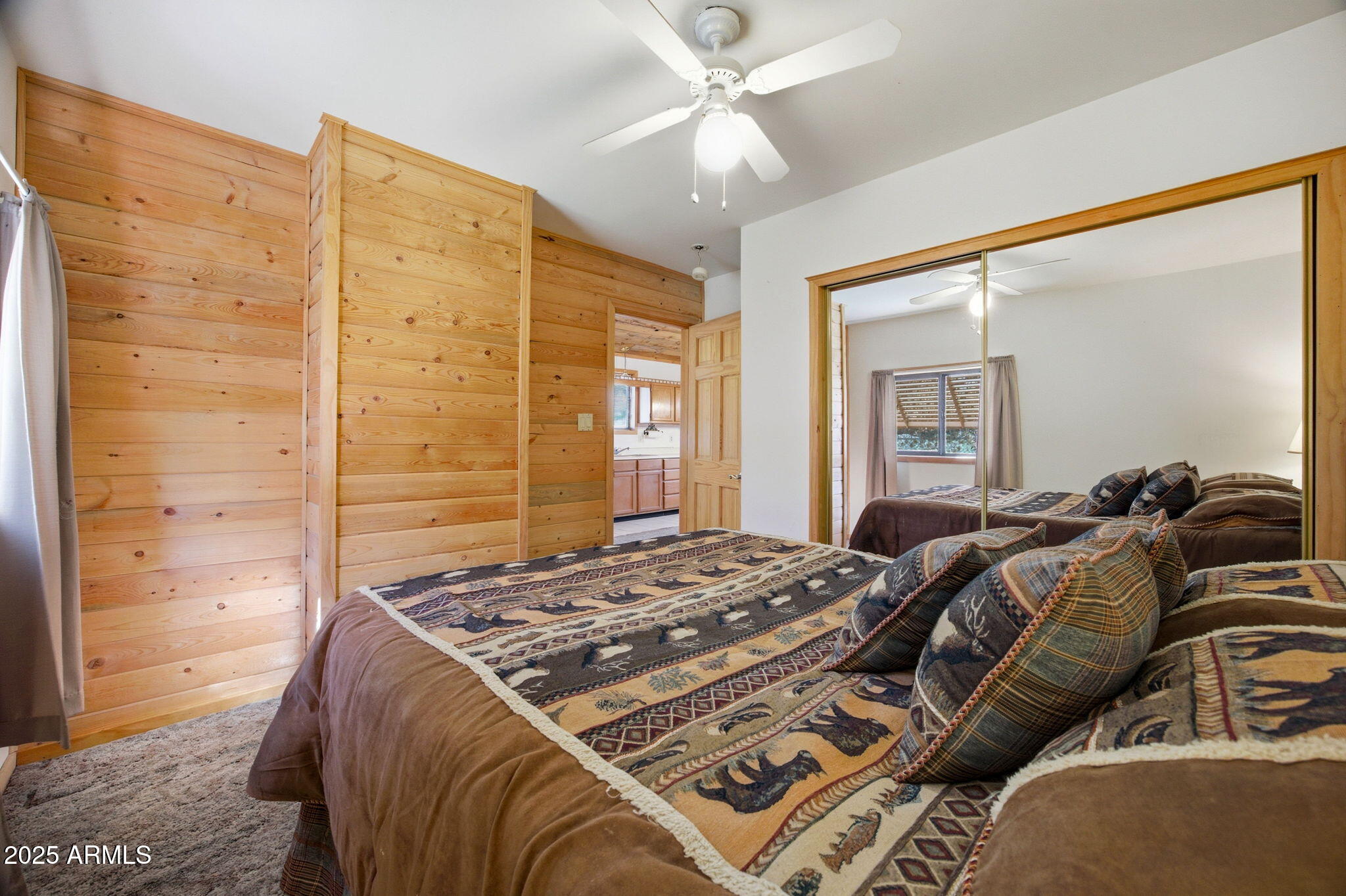 3157 Tonto Drive Overgaard, AZ 85933 - Photo 13 of 22 a bed sitting in a bedroom next to a window and a chandelier
