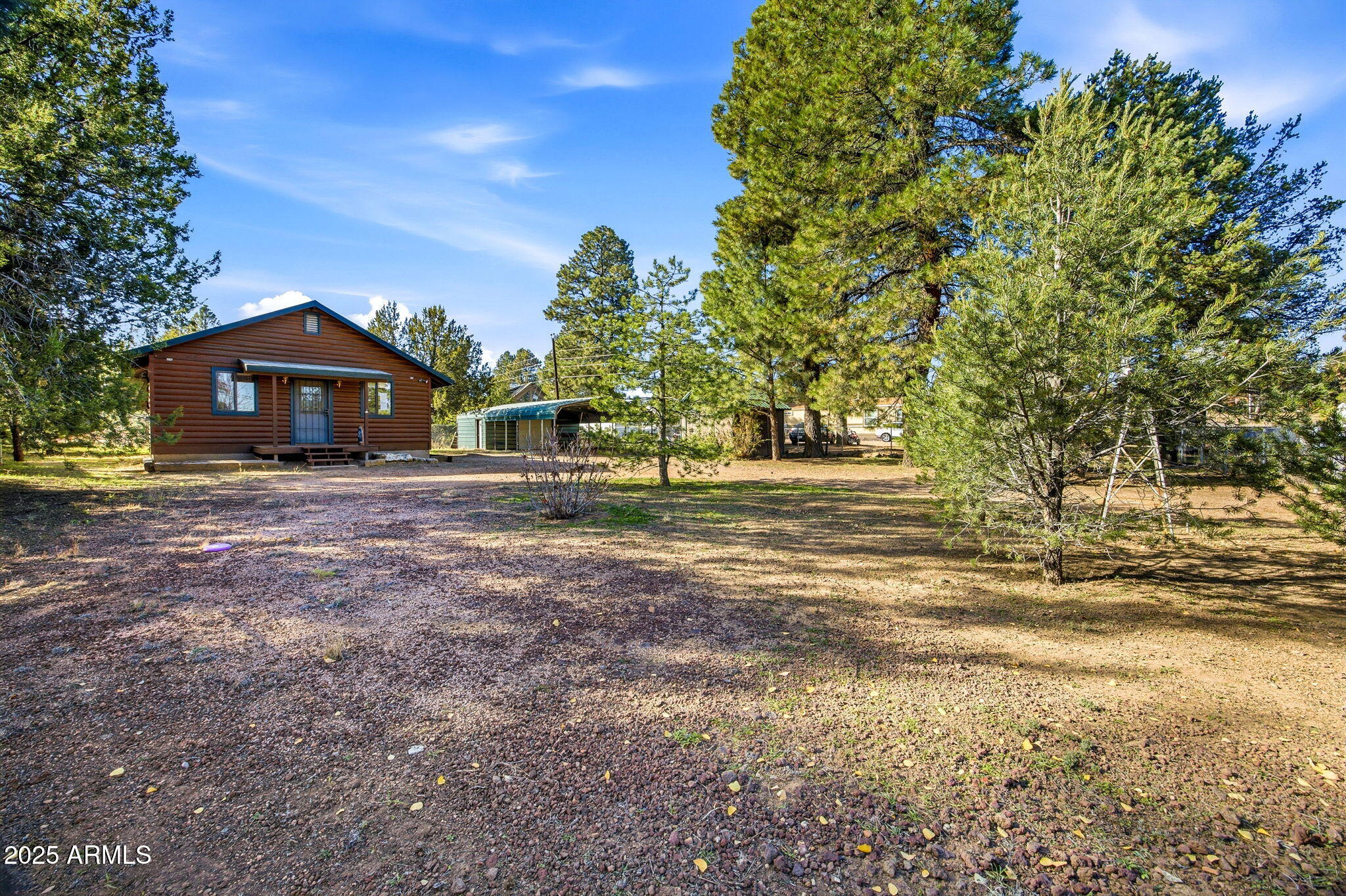 3157 Tonto Drive Overgaard, AZ 85933 - Photo 2 of 22 a front view of a house with a yard