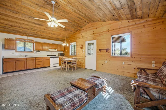 a living room with furniture and a kitchen