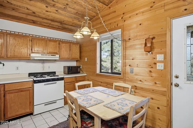 a kitchen with a stove a sink a refrigerator and cabinets