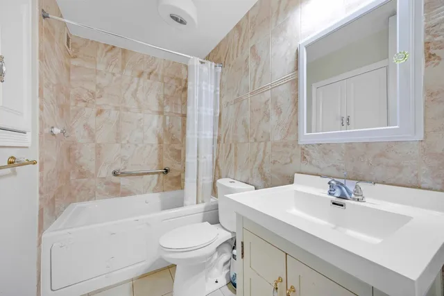 a bathroom with a sink a toilet and a bathtub