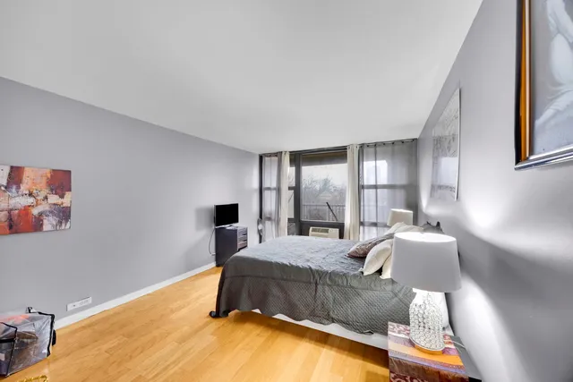 a bedroom with a bed and window