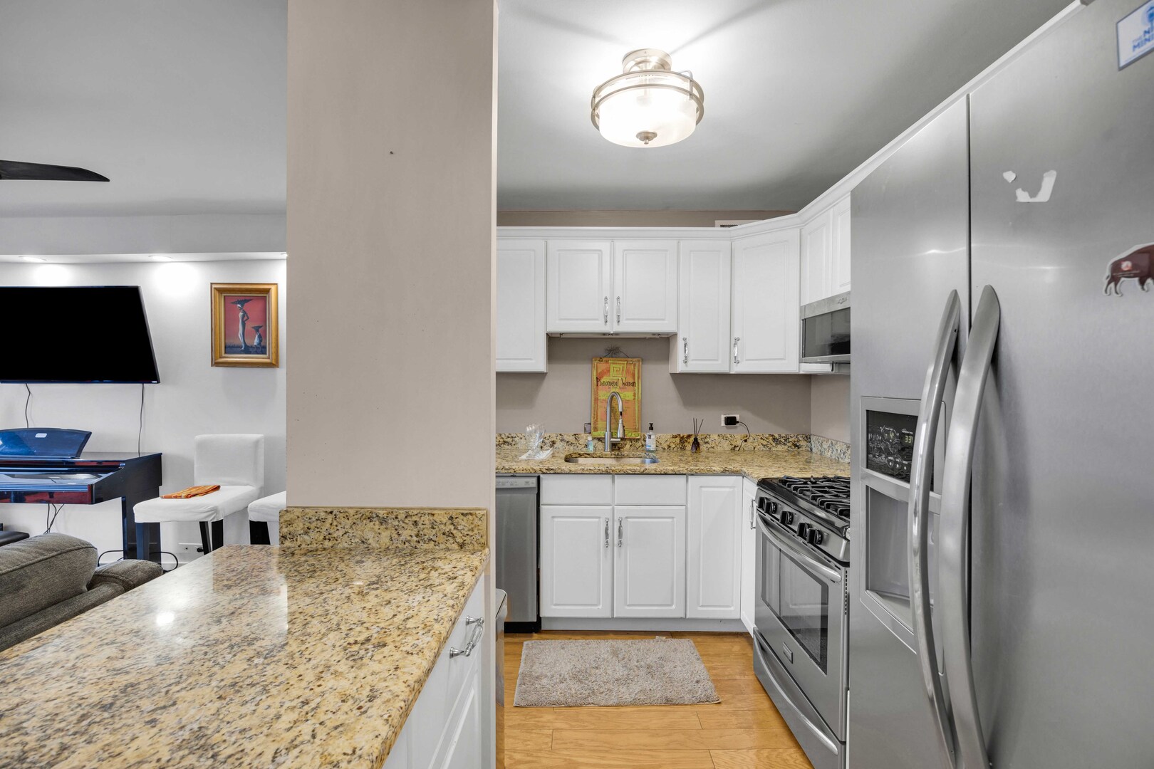 2605 South Indiana Avenue, Unit 403 Chicago, IL 60616 - Photo 5 of 16 a kitchen with stainless steel appliances granite countertop a refrigerator stove microwave and sink