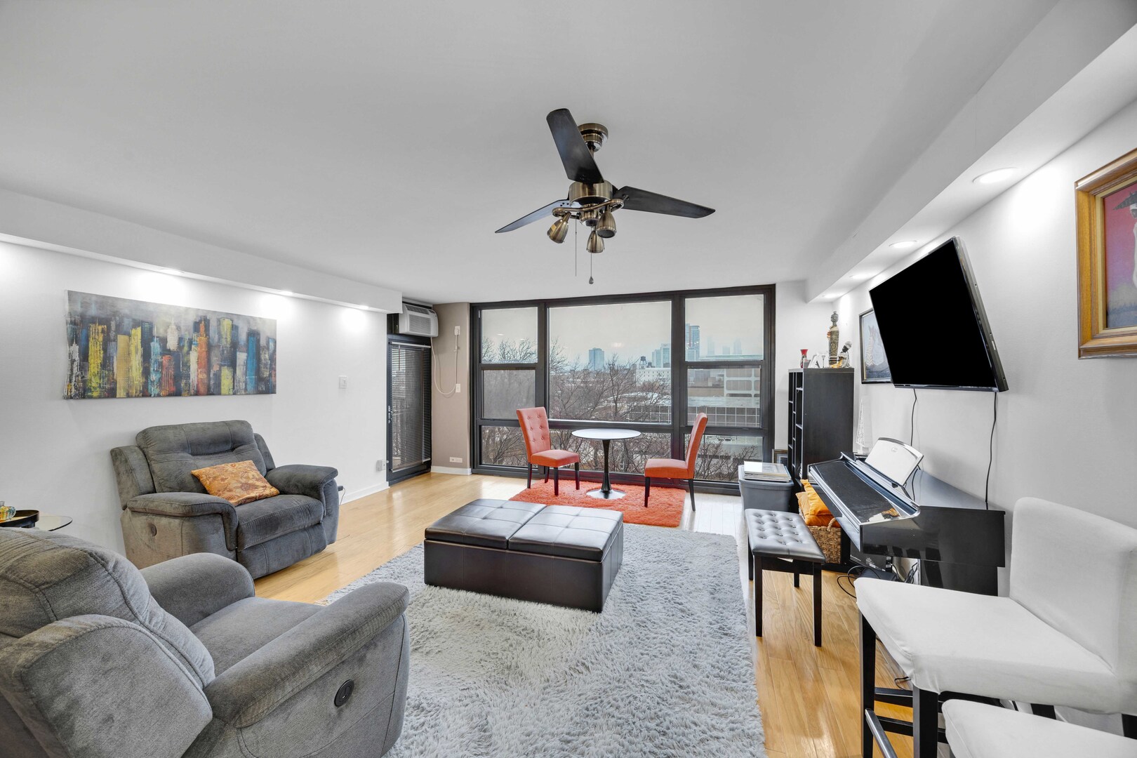 2605 South Indiana Avenue, Unit 403 Chicago, IL 60616 - Photo 7 of 16 a living room with furniture a flat screen tv and a large window