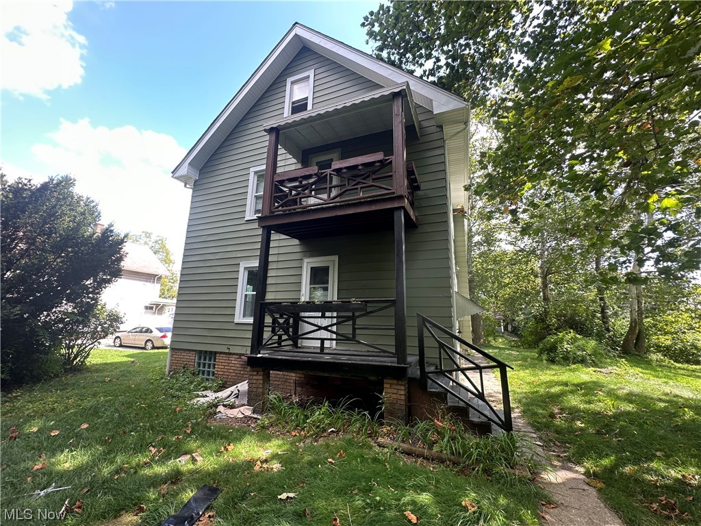 10820 Bellaire Road Cleveland, OH 44111 - Photo 22 of 24 Rear view of house featuring balcony and a lawn