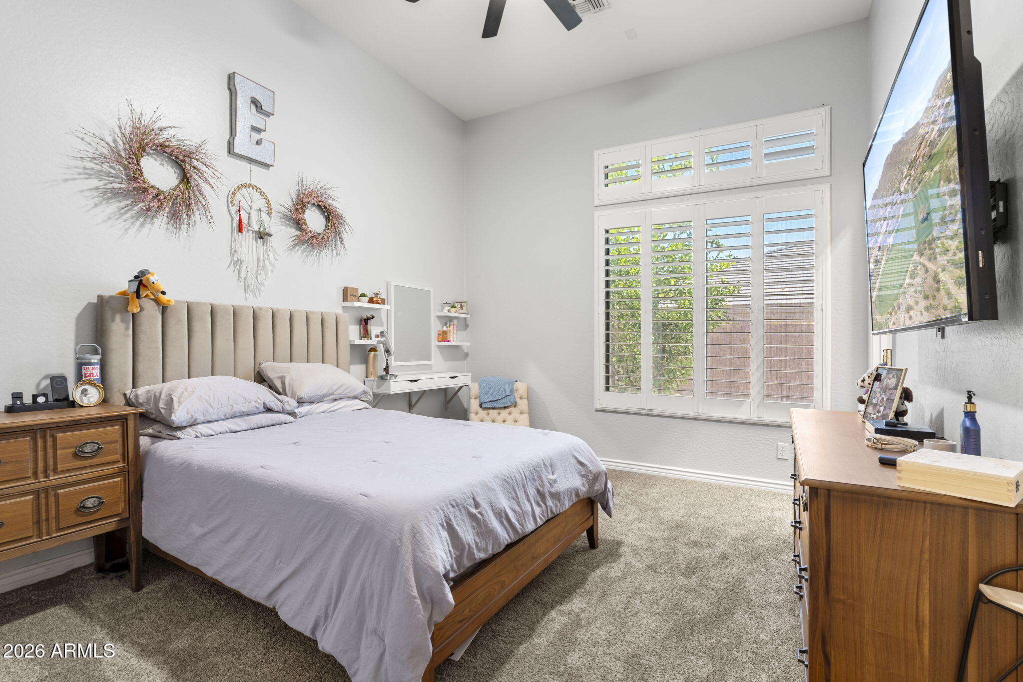 41619 North River Bend Road Anthem, AZ 85086 - Photo 22 of 84 a bedroom with a bed and a chandelier