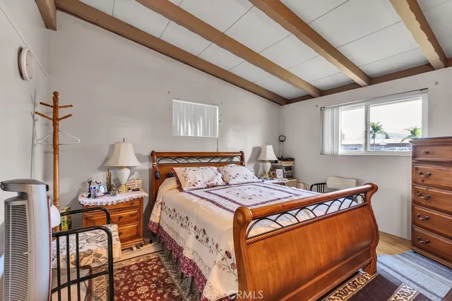 a bed sitting in a bedroom next to a window