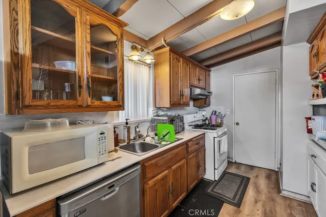 a kitchen with stainless steel appliances a stove and a sink