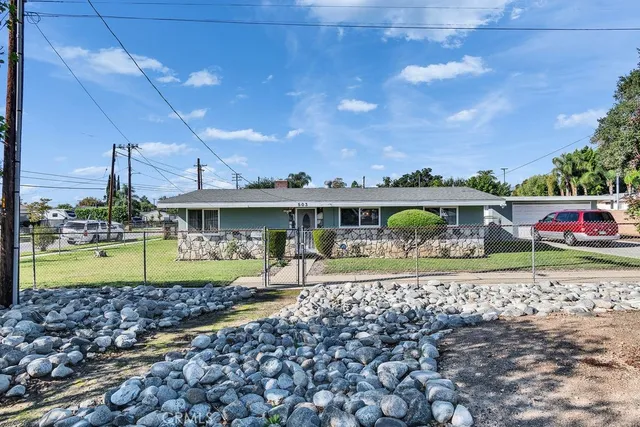 a front view of a house with garden