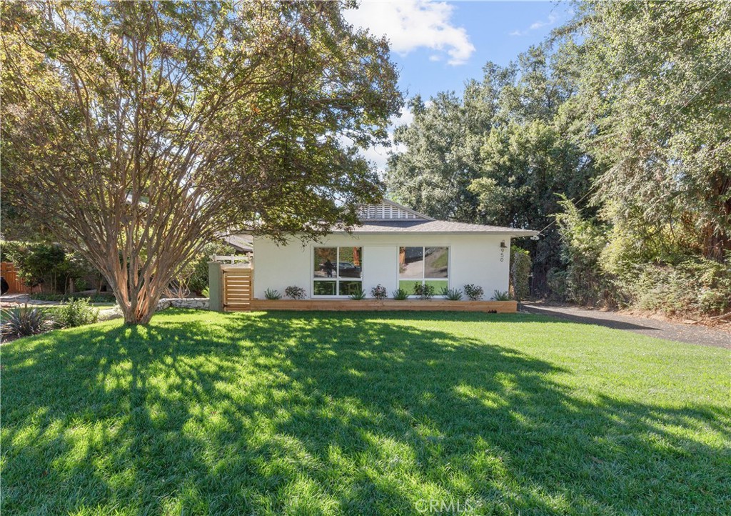 a front view of a house with yard patio and green space