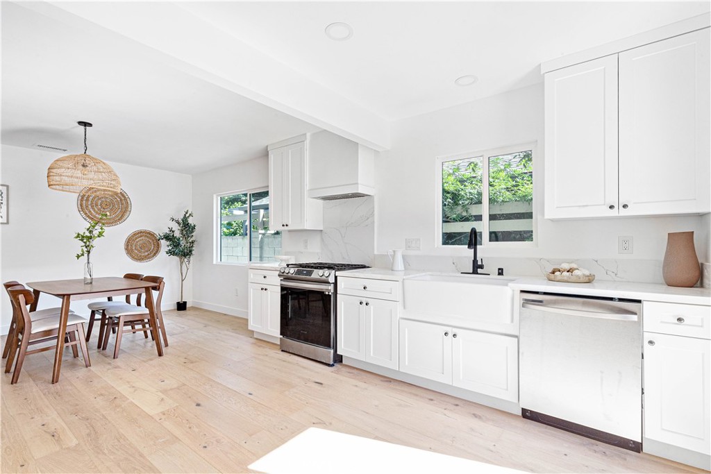 950 Morada Place Altadena, CA 91001 - Photo 11 of 30 a kitchen with a stove a sink a dining table and chairs