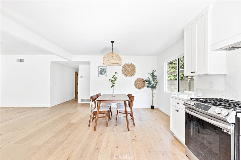 950 Morada Place Altadena, CA 91001 - Photo 14 of 30 a kitchen with a table chairs a stove and a window